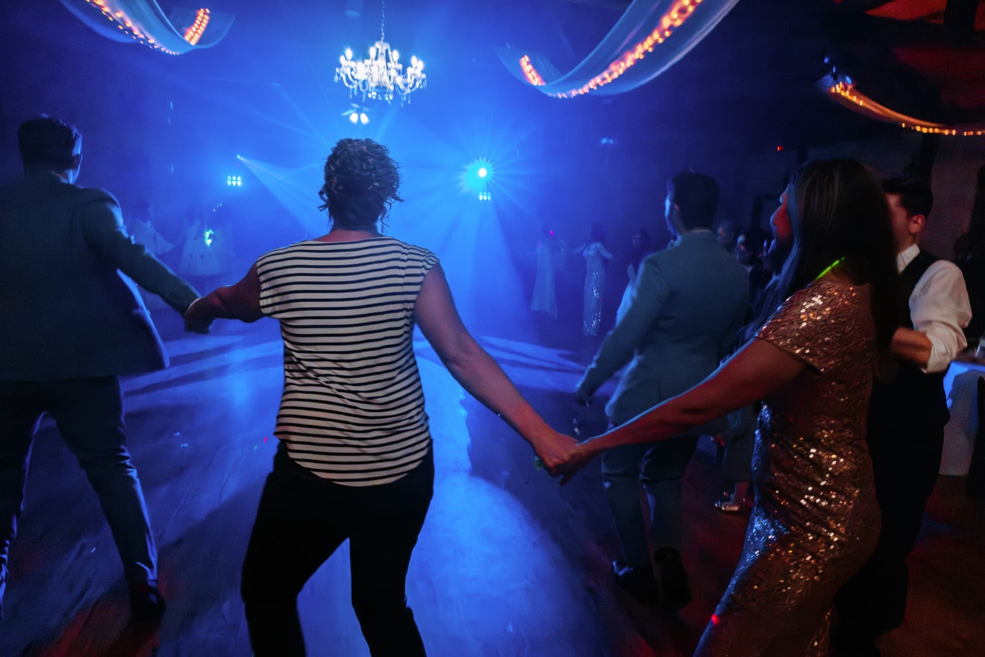 Guests dancing under string lights at the McRae wedding