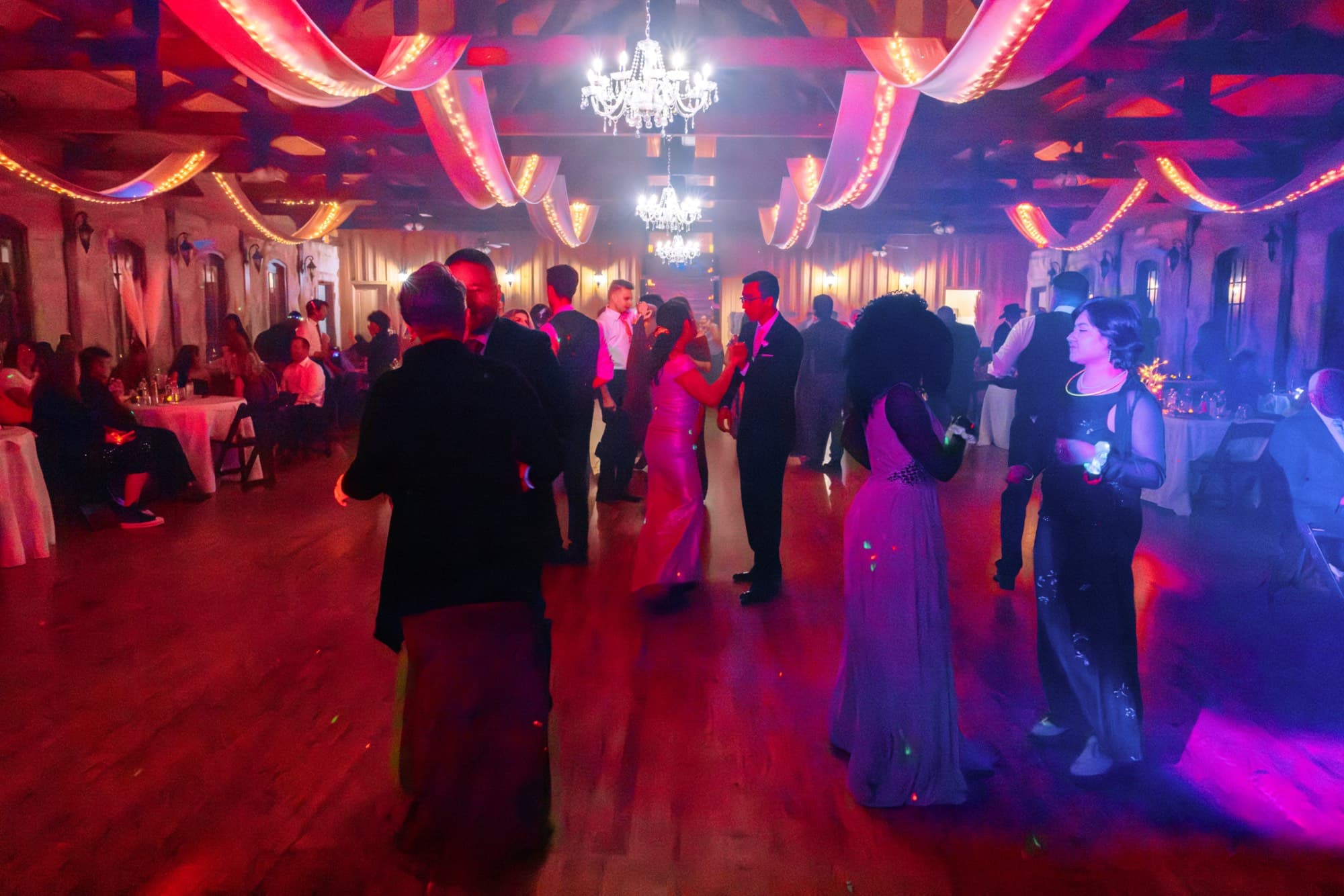 Elegant reception hall with chandeliers and string lights at the McRae wedding
